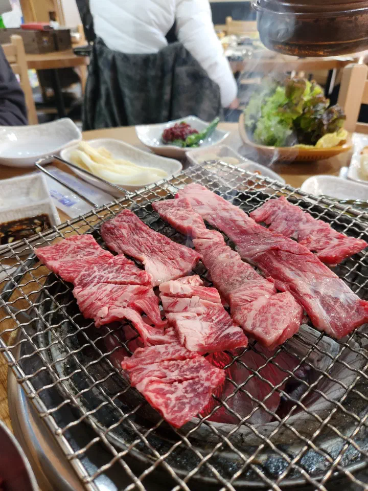 Hanwoo galbi cooking on the charcoal grill