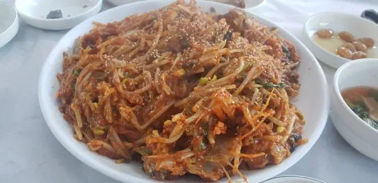 Plate of monkfish braised with crunchy bean sprouts and mideodeok sea squirts in spicy sauce