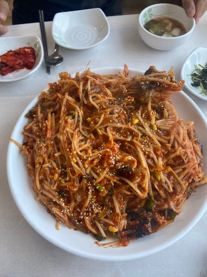 Full table setting at Jeonsan Garden with a small-size agujjim, side dishes and soup