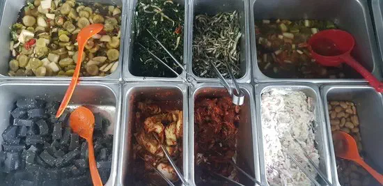 Self-serve banchan bar at Jeonsan Garden with seaweed salad, braised sword beans, kimchi and other Gyeongsang-style side dishes