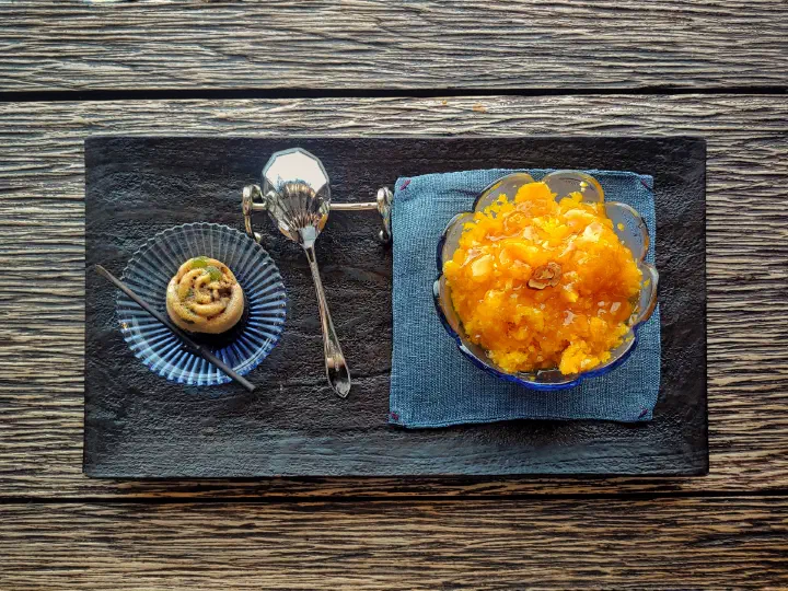 Close-up of danhobak bingsu, sweet pumpkin shaved ice topped with grain syrup, at Bibibidang