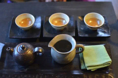 Traditional Korean tea set at Bibibidang with teapot, pitcher, and three cups of hwangcha