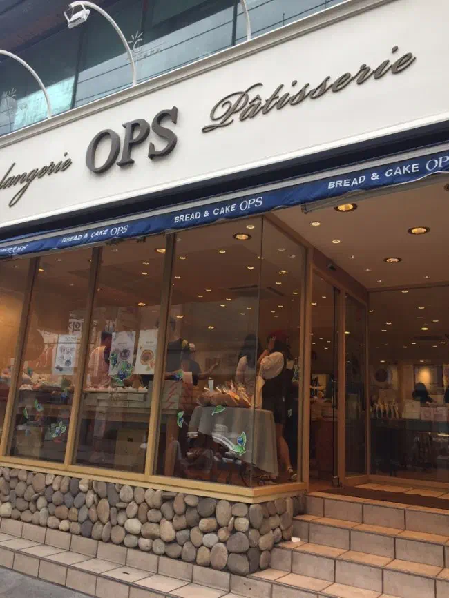 Exterior of OPS Haeundae bakery with its OPS Boulangerie Patisserie sign at the entrance of Haeundae Market in Busan