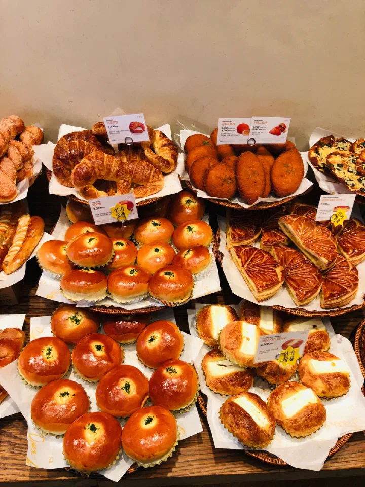 Bread display at OPS Haeundae bakery with croissants, cream cheese danishes, croquettes and red bean buns