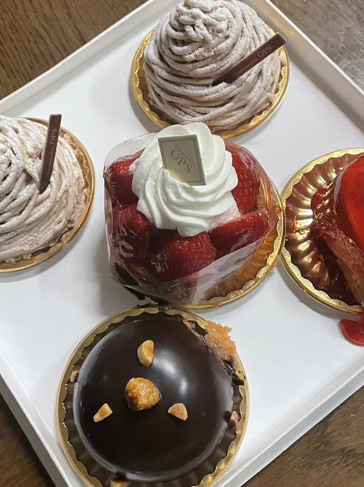 OPS cake slices — mont blanc, strawberry cream cake and chocolate cake on a white tray