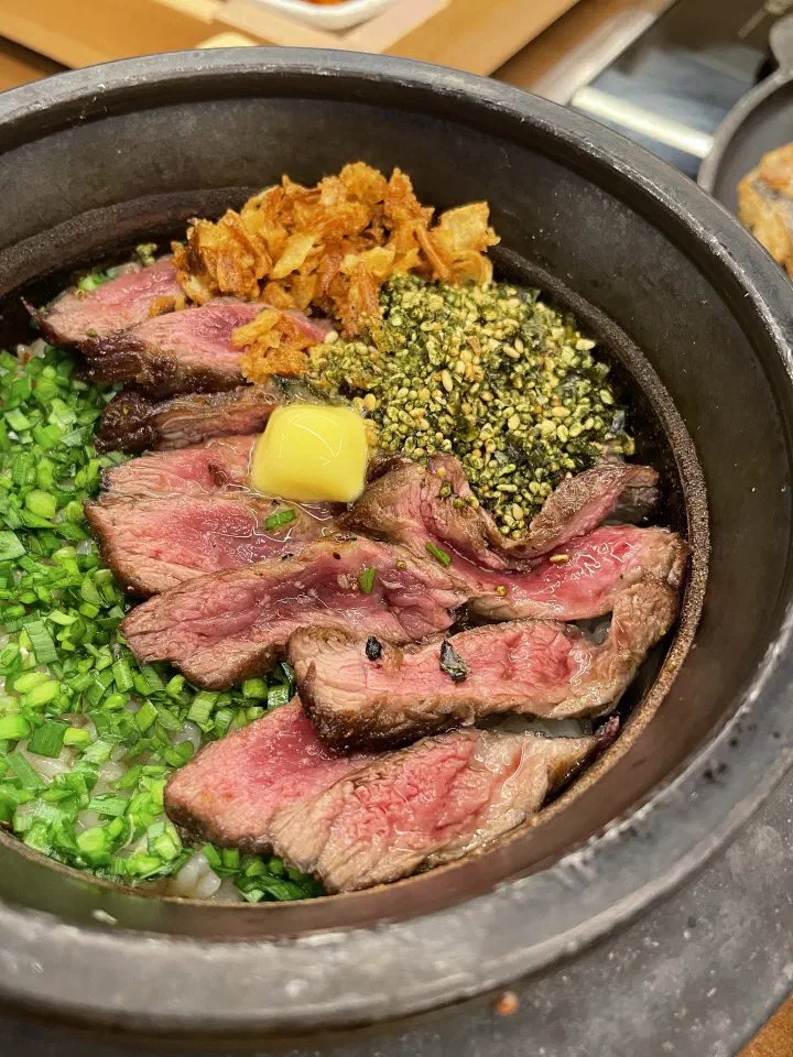 Handasot galbi sotbap, sliced beef over rice in a stone pot
