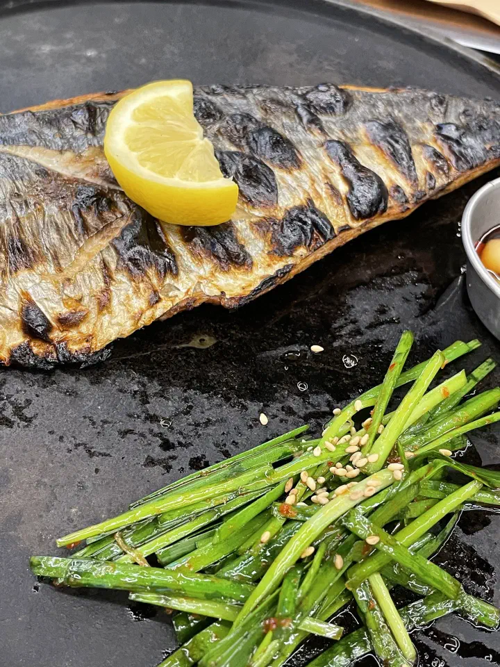 Charcoal-grilled fish with seasoned greens at Handasot
