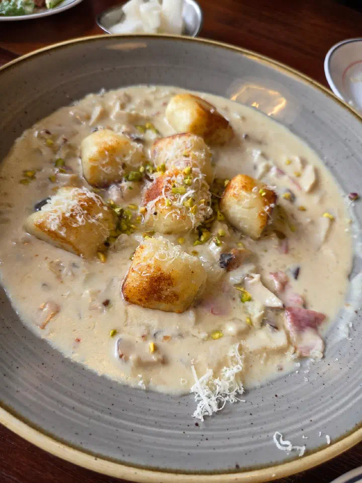 Mushroom gorgonzola gnocchi at Cheongchun Kitchen, seared gnocchi in a rich cream sauce topped with pistachio