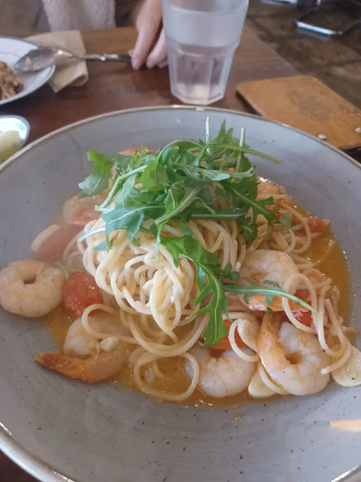 Shrimp pasta at Cheongchun Kitchen, an oil-based spaghetti topped with arugula and plenty of shrimp