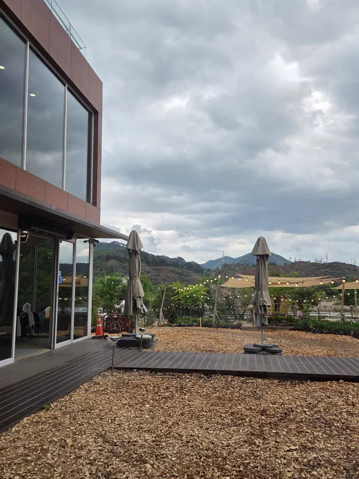 Outdoor deck seating at Gamzabatt with mountain views in Chuncheon