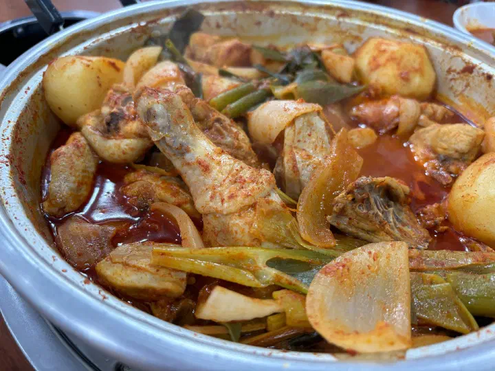 Chicken drumstick and big chunks of potato in the spicy stew at Hanyeong Sikdang