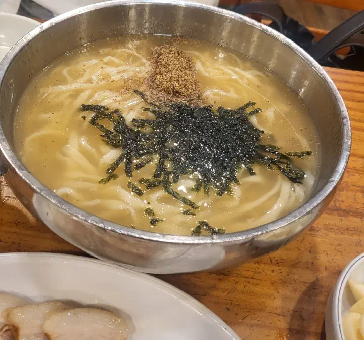 Kalguksu broth turned creamy and rich after the perilla powder is stirred in