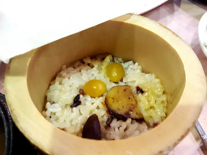 Steam rising from freshly opened bamboo-tube rice at Hansangeun Daetongbapjip