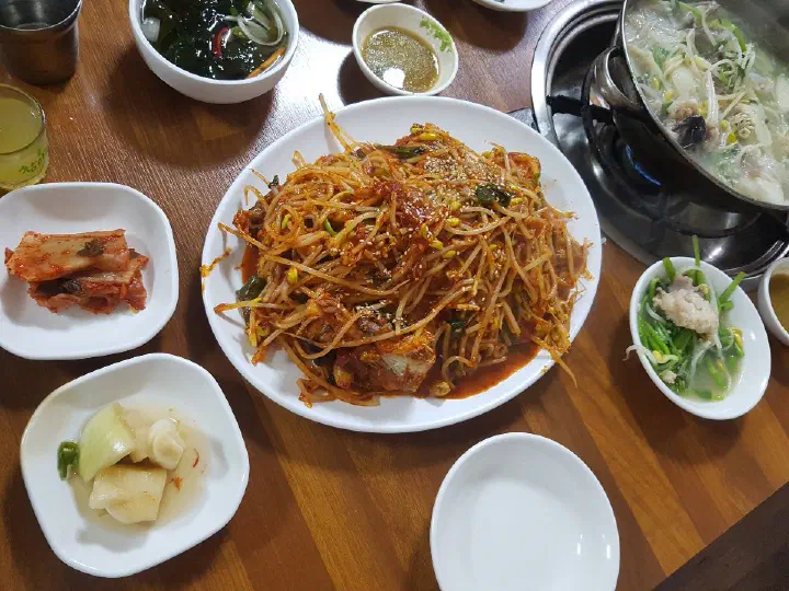 Full Samdado table with agujjim, clear monkfish stew, kimchi and assorted banchan
