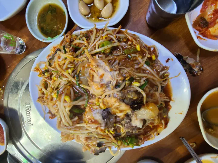 Plate of Samdado agujjim, spicy braised monkfish piled with thick bean sprouts