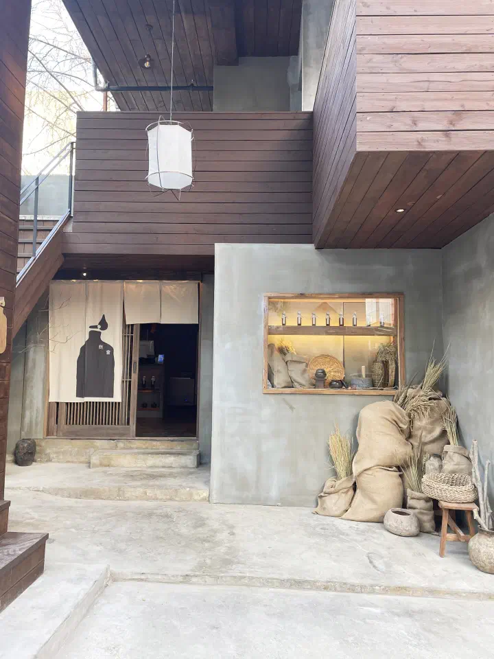 Daytime exterior of Apgujeong Sanghoe with its noren curtain entrance in a Gangnam back alley