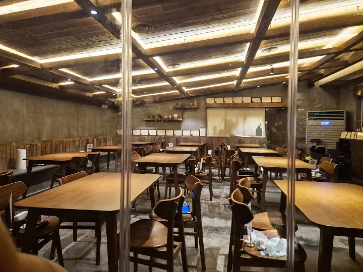 Wooden tables still empty in the large ground floor hall at Apgujeong Sanghoe
