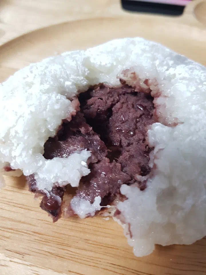 Cross-section of Chamsoon Chaltteokbang white mochi filled with unsweet red bean paste