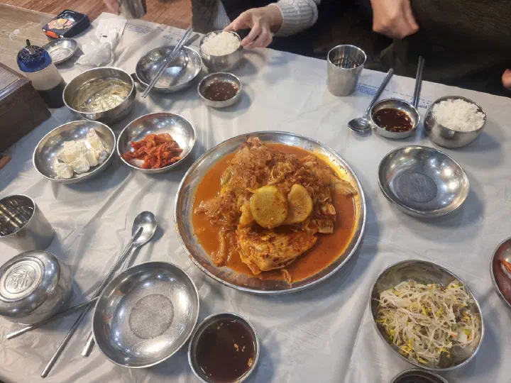 Two thin slices of braised radish sitting on top of the skate at Goseong Saengseonjjim