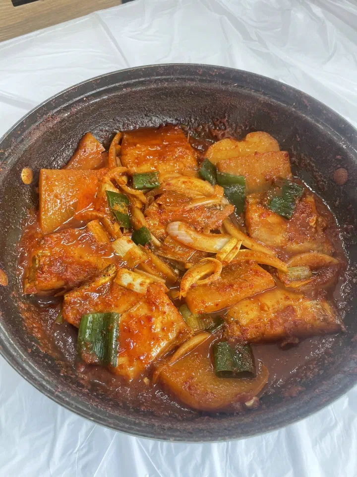 Overhead view of the hairtail pot with large slices of sauce-soaked Korean radish