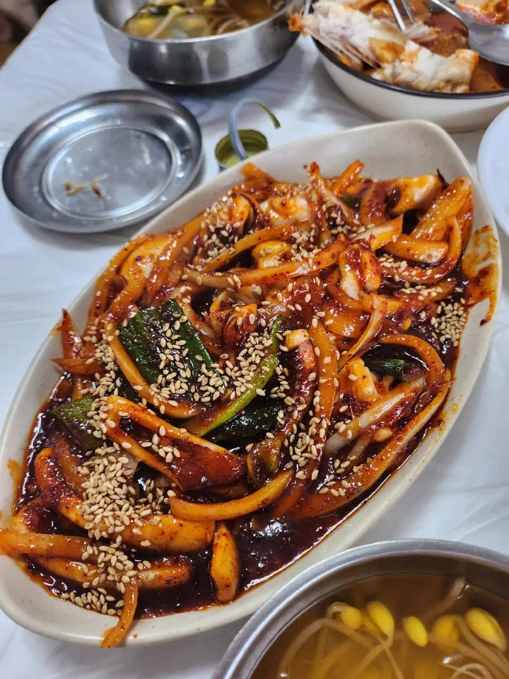 Korean stir-fried squid loaded with sliced onion and green scallion