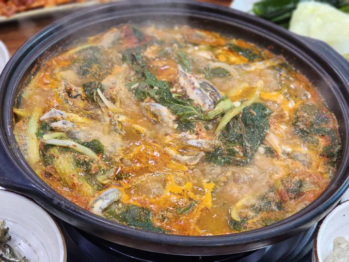 Geoje Myeolchi Ssambap whole anchovy stew bubbling away on the burner