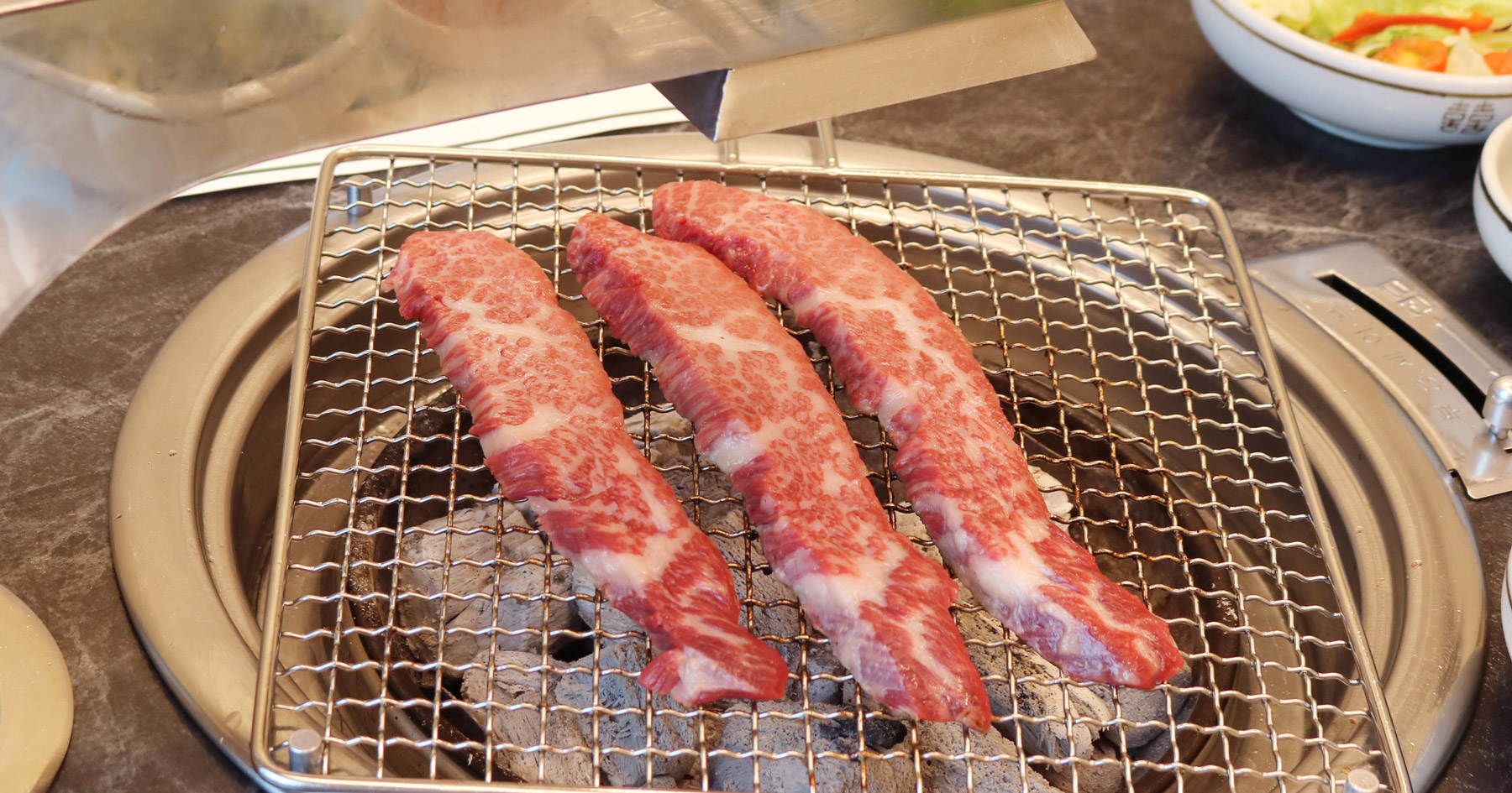 Charcoal-grilled hanwoo sirloin and galbisal spread at Cheolma Hanwoo Chowon, Gijang