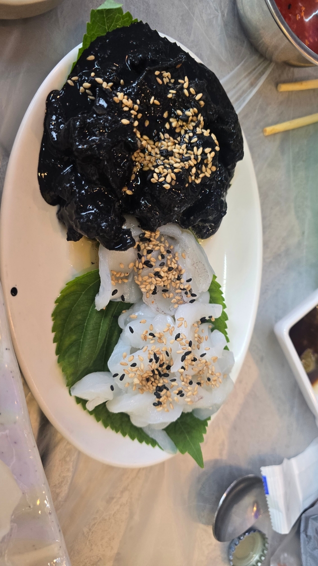 Cuttlefish sashimi served with its ink