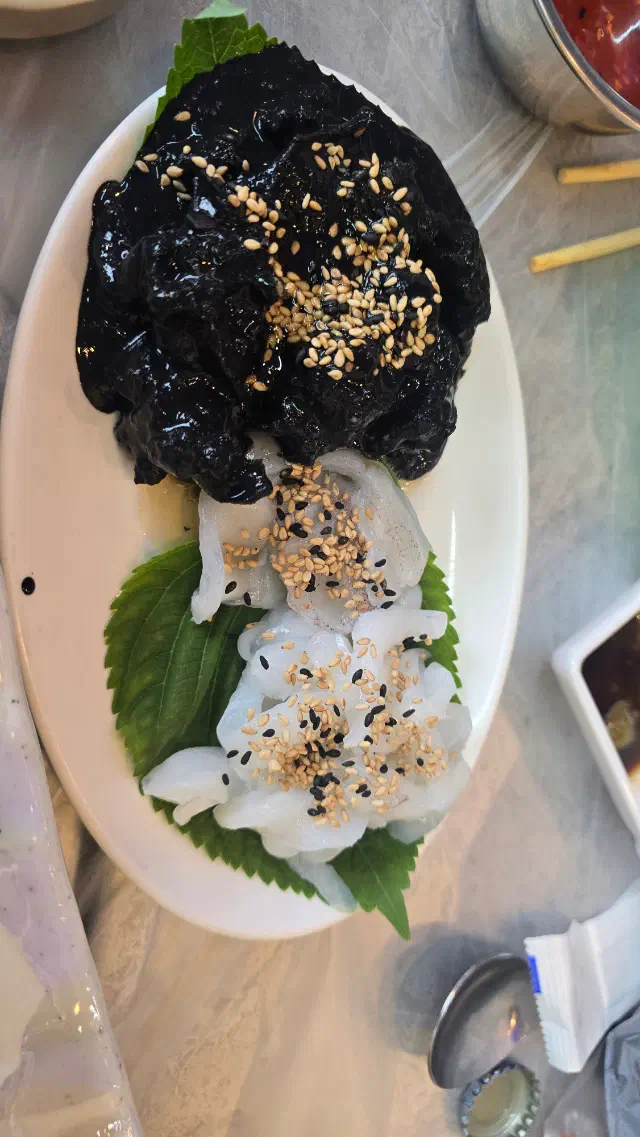 Cuttlefish sashimi served with its ink