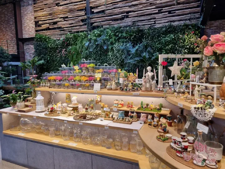 Decorative goods displayed against a vertical garden wall at The Road 101 shop