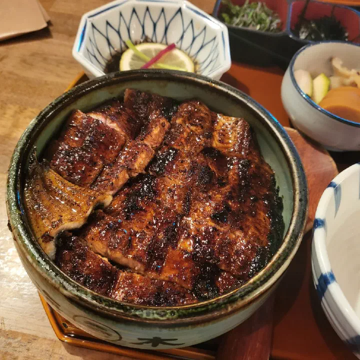 Close-up of charcoal-grilled eel glazed three times over rice at Haemok