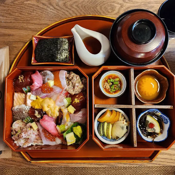 Overhead view of the kaisendon seafood bowl tray at Haemok, Busan