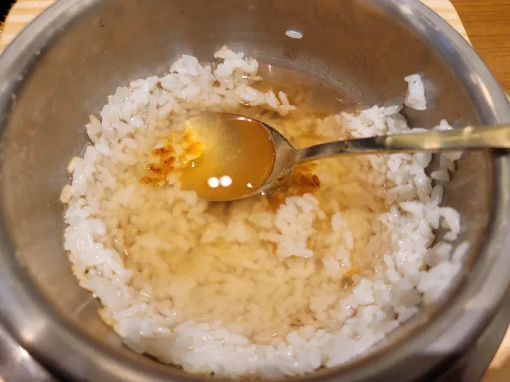 Stone-pot rice scooped into a bowl at Saerijae