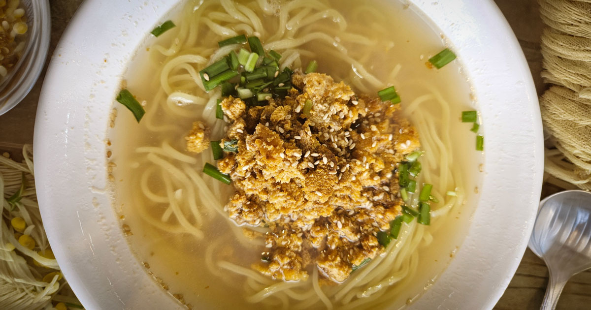 Sea urchin noodle soup at Gommak Sikdang with the Gujwa coastline through the window