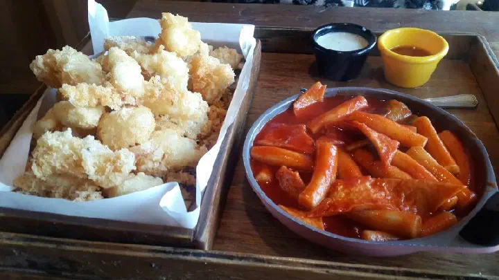Pyeongdae Snack two-person set of hanchi squid tempura and soupy tteokbokki on a tray