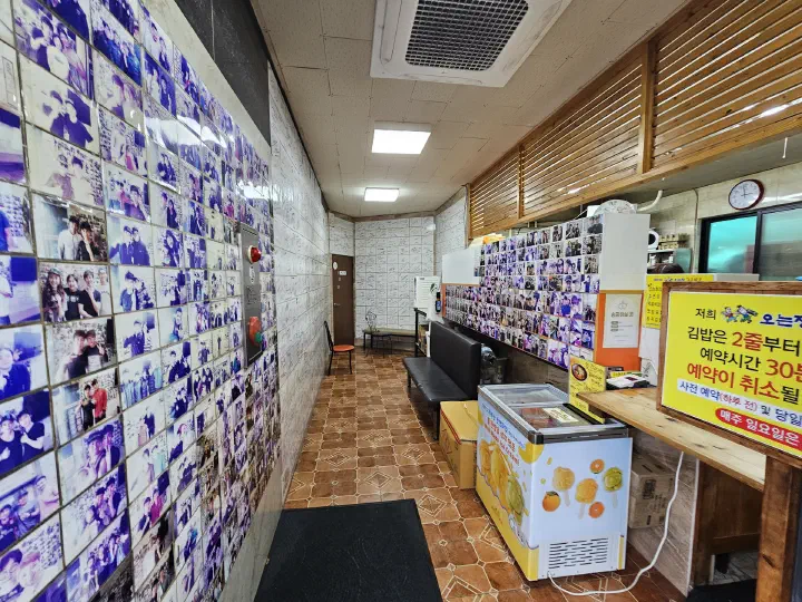 Interior wall of Oneunjeong Gimbap covered with Korean celebrity autographs and photos