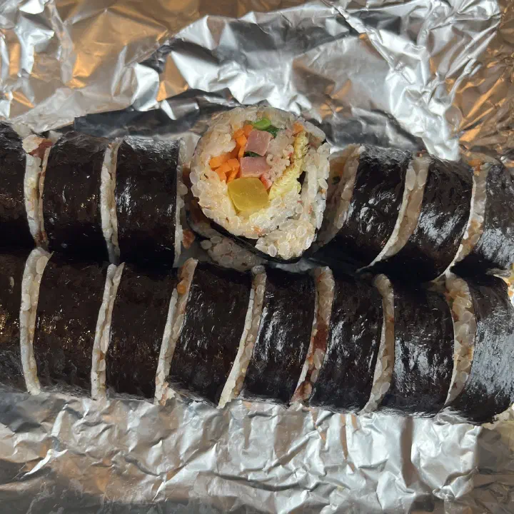 Close-up cross-section of a freshly rolled, warm Oneunjeong gimbap
