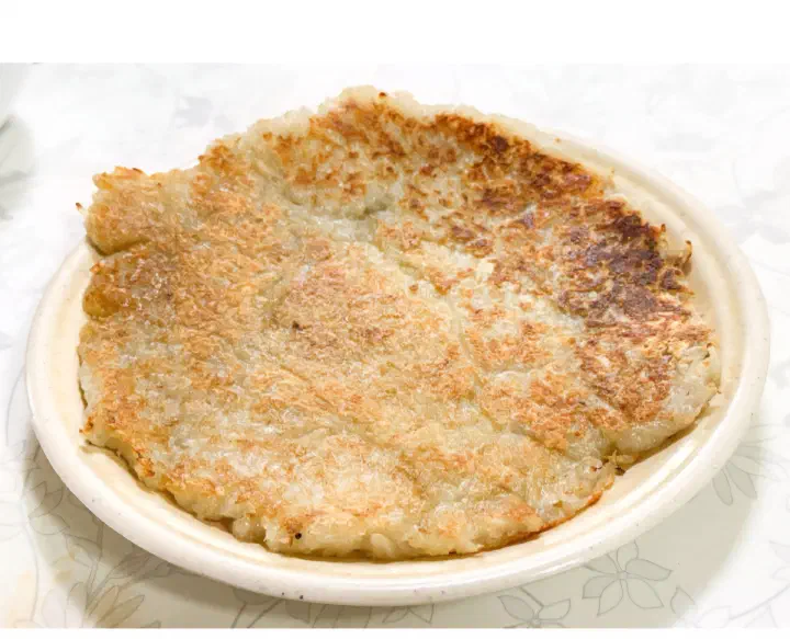 Golden pan-fried gamja-jeon potato pancake made from grated potato at Samcheongdong Sujebi