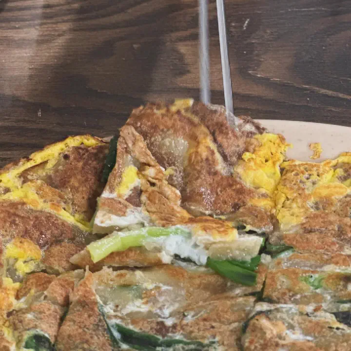 Egg-battered green onion pajeon in the soft Dongnae style at Samcheongdong Sujebi