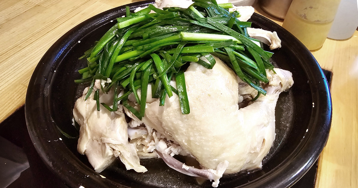 Ibuk-style steamed chicken topped with garlic chives at Jinnampo Noodle