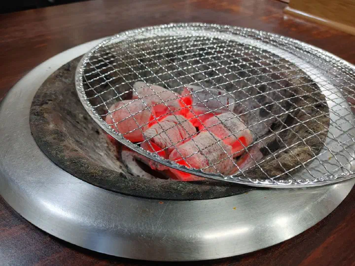 충무로쭈꾸미불고기 벌겋게 달아오른 참숯 화로와 그 위에 올린 석쇠