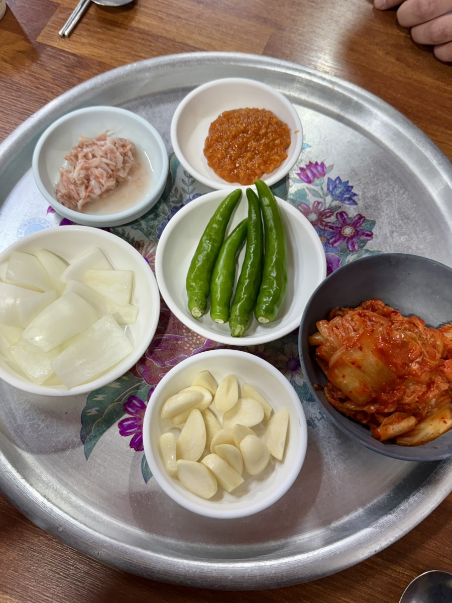 Close-up of well-aged kimchi alongside other banchan