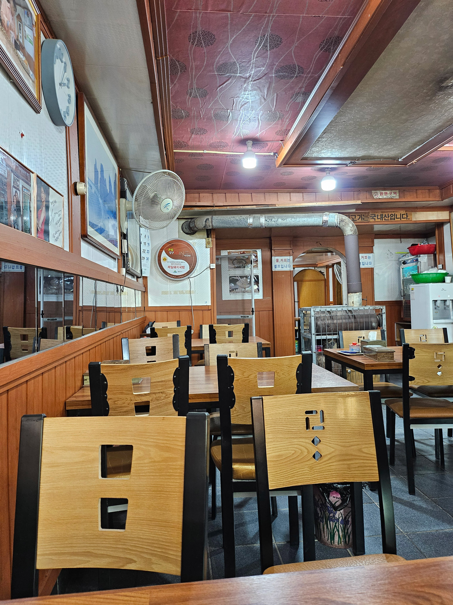 Wooden tables and worn walls inside Jeilsikdang’s front hall