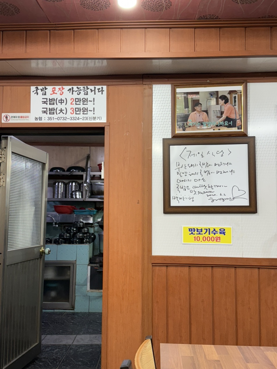Notices and the autograph display by the kitchen doorway
