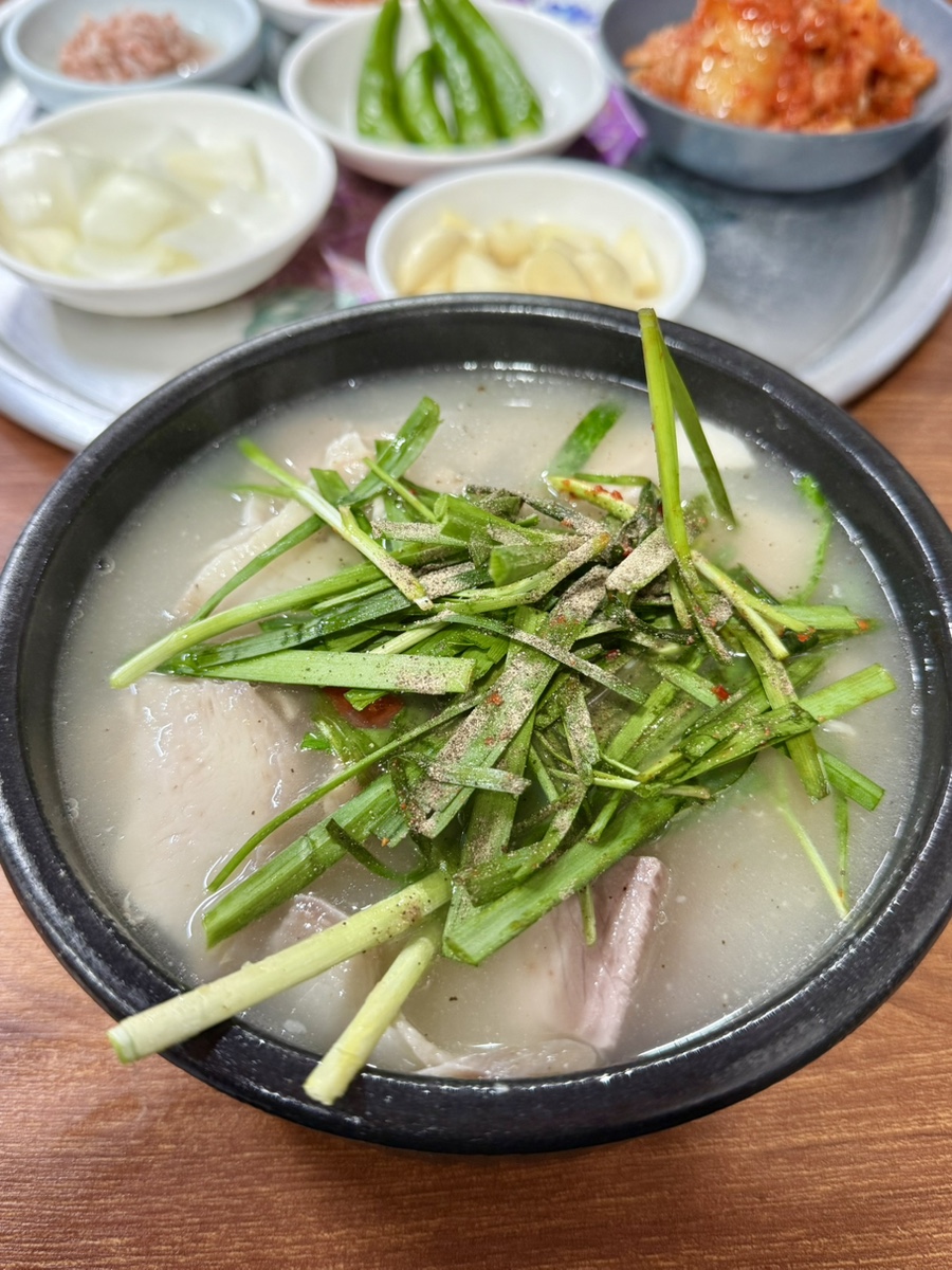 Garlic chives piled high on a bowl of Miryang-style pork soup