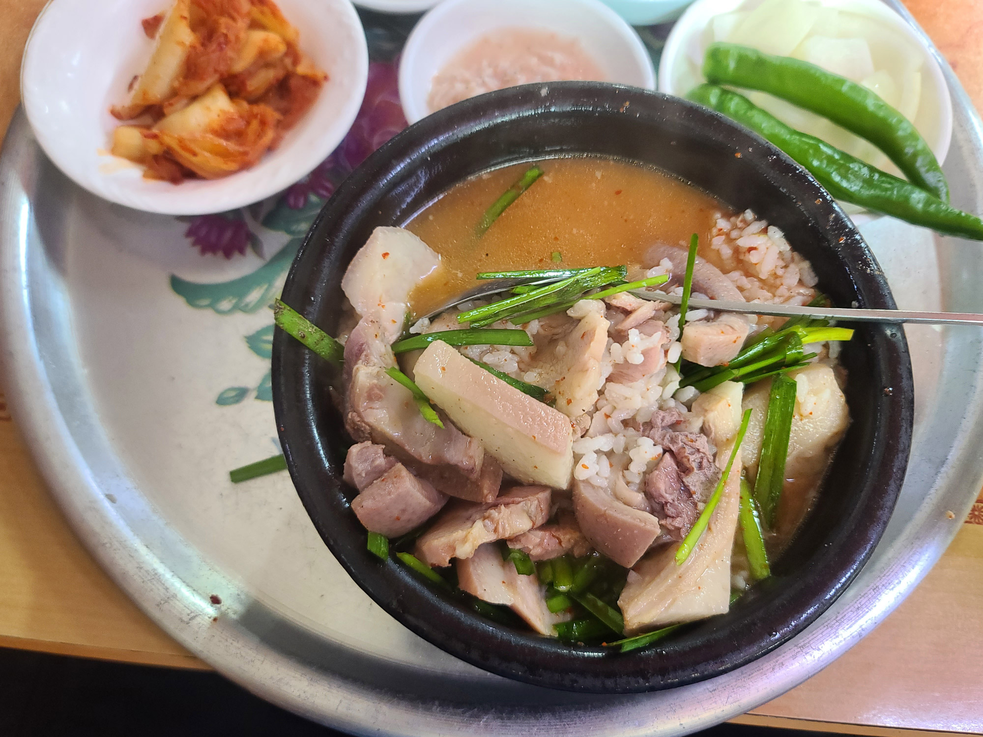 A close-up of a freshly served bowl of Miryang dwaeji-gukbap