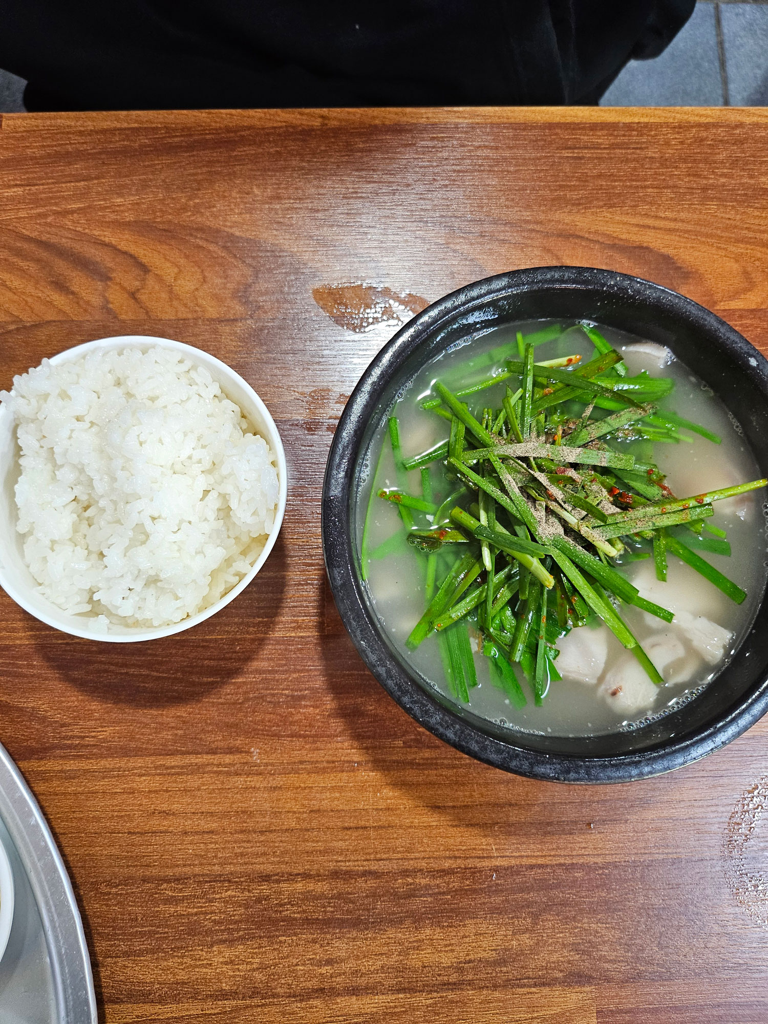 Spoonful of broth-soaked rice from the gukbap bowl