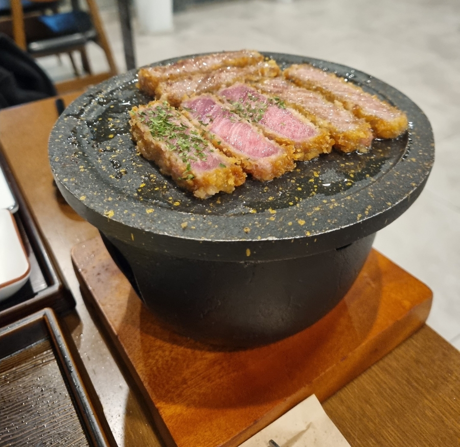 Grilling gyukatsu on tabletop stone grill at Misyuldang Ulsan