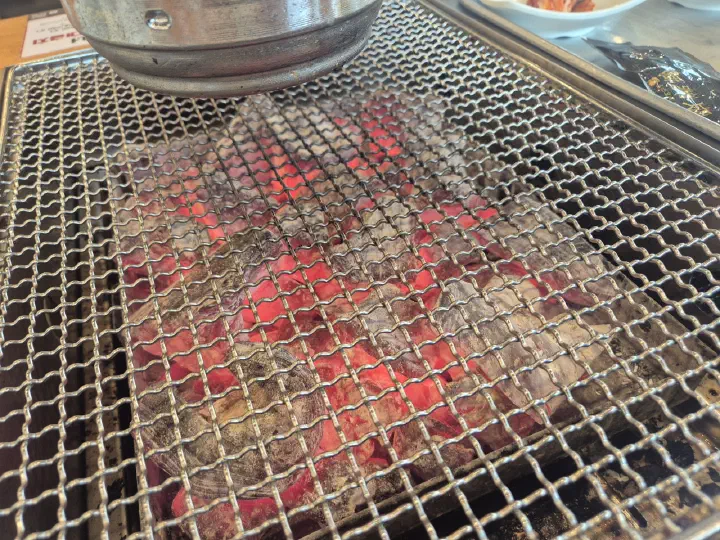 Glowing red charcoal fire under the grill grate