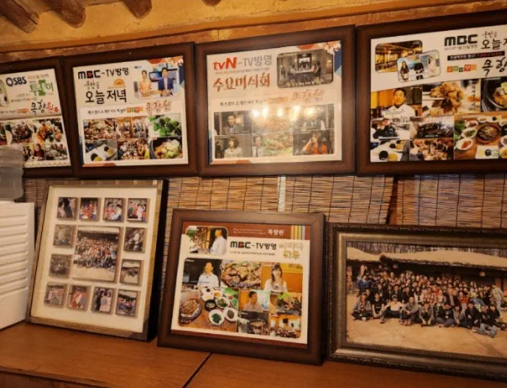Framed Korean TV show features on the wall of Mokhyangwon, including tvN Wednesday Food Talk and MBC evening programs